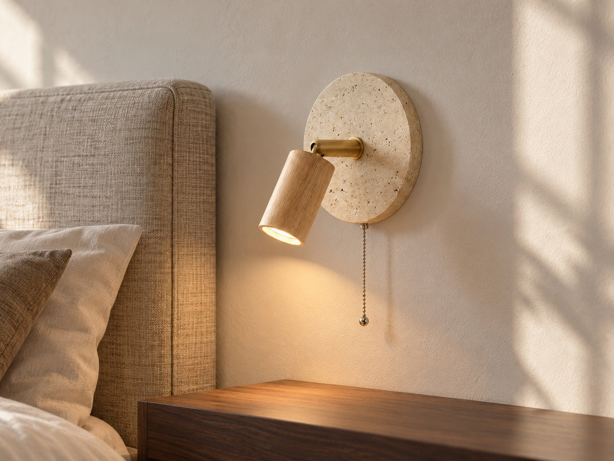 Primrose Light Wood wall light beside a linen headboard in a styled interior