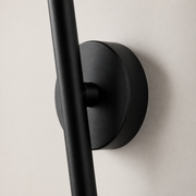 Close-up of the Aaradhya black wall light pivot and circular wall plate