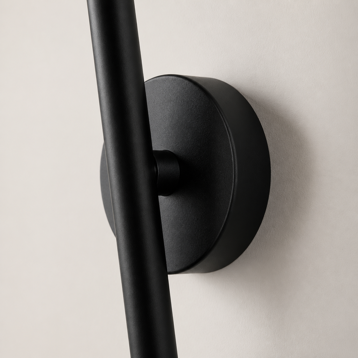 Close-up of the Aaradhya black wall light pivot and circular wall plate