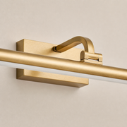 Close-up of the Auburn brushed-gold wall mount, curved support and underside diffuser