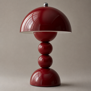 Close-up of the Aveline cordless table lamp in a glossy deep red finish