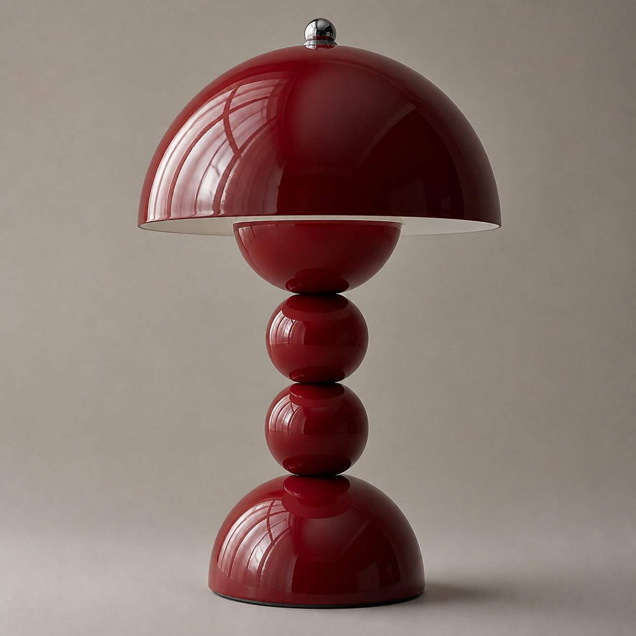 Close-up of the Aveline cordless table lamp in a glossy deep red finish