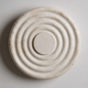 Close-up of the Avon round wall light's concentric textured resin surface