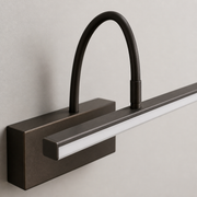 Close-up of the Barton rechargeable wall light's curved arm, mount and diffuser