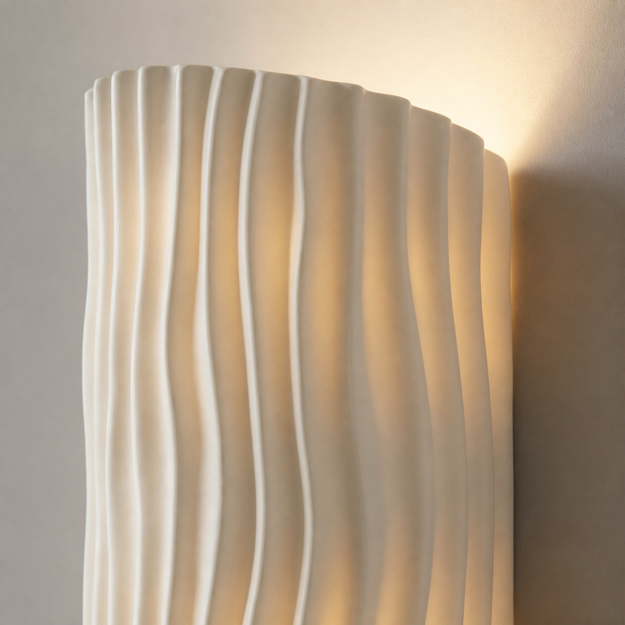 Close-up of the white Corby wall light's flowing ribbed resin surface