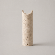Dorset travertine wall light in the beige stone finish on a neutral background