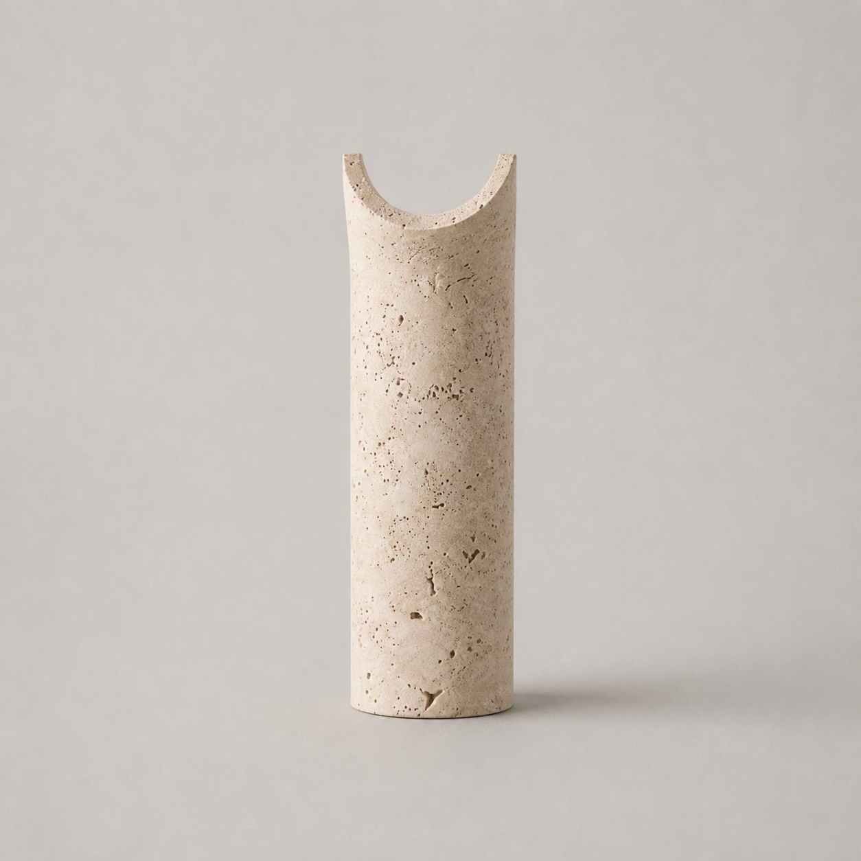 Dorset travertine wall light in the beige stone finish on a neutral background