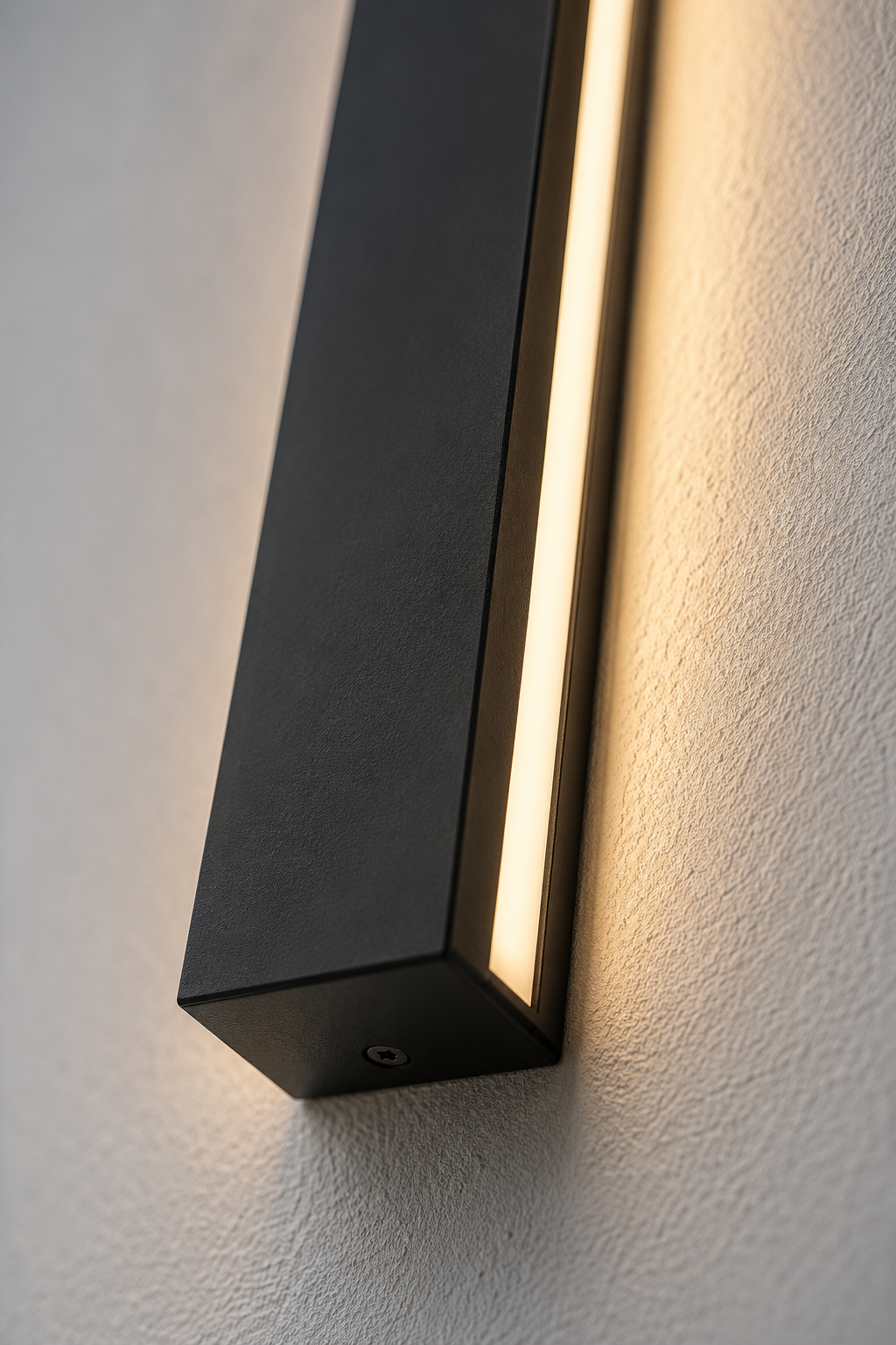Close-up of the Ealing linear outdoor wall light matte black housing and warm LED strip