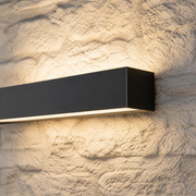 Close-up of the Ealing Long matte black metal bar and concealed warm diffuser
