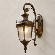 Ornate bronze Ely outdoor wall light with ribbed glass lantern