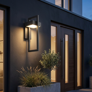 Bayswater Large Geometric Outdoor Wall Light illuminated beside a front door entrance at dusk