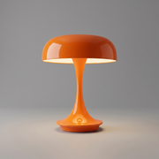 Orange cordless table lamp switched on with a soft warm glow