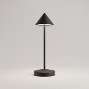 Black cordless table lamp on a clean studio background