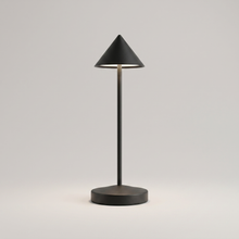 Black cordless table lamp on a clean studio background