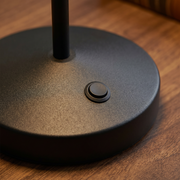 Close-up of the black cordless table lamp base and switch detail