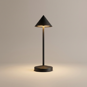 Black cordless table lamp switched on with a soft warm glow