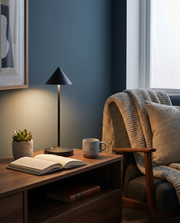Black cordless table lamp glowing on a living room side table