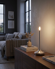 Silver cordless table lamp glowing on a console table in a warm room