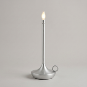 Silver cordless table lamp on a clean studio background