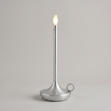 Silver cordless table lamp on a clean studio background
