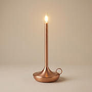 Copper cordless table lamp switched on with a soft warm glow