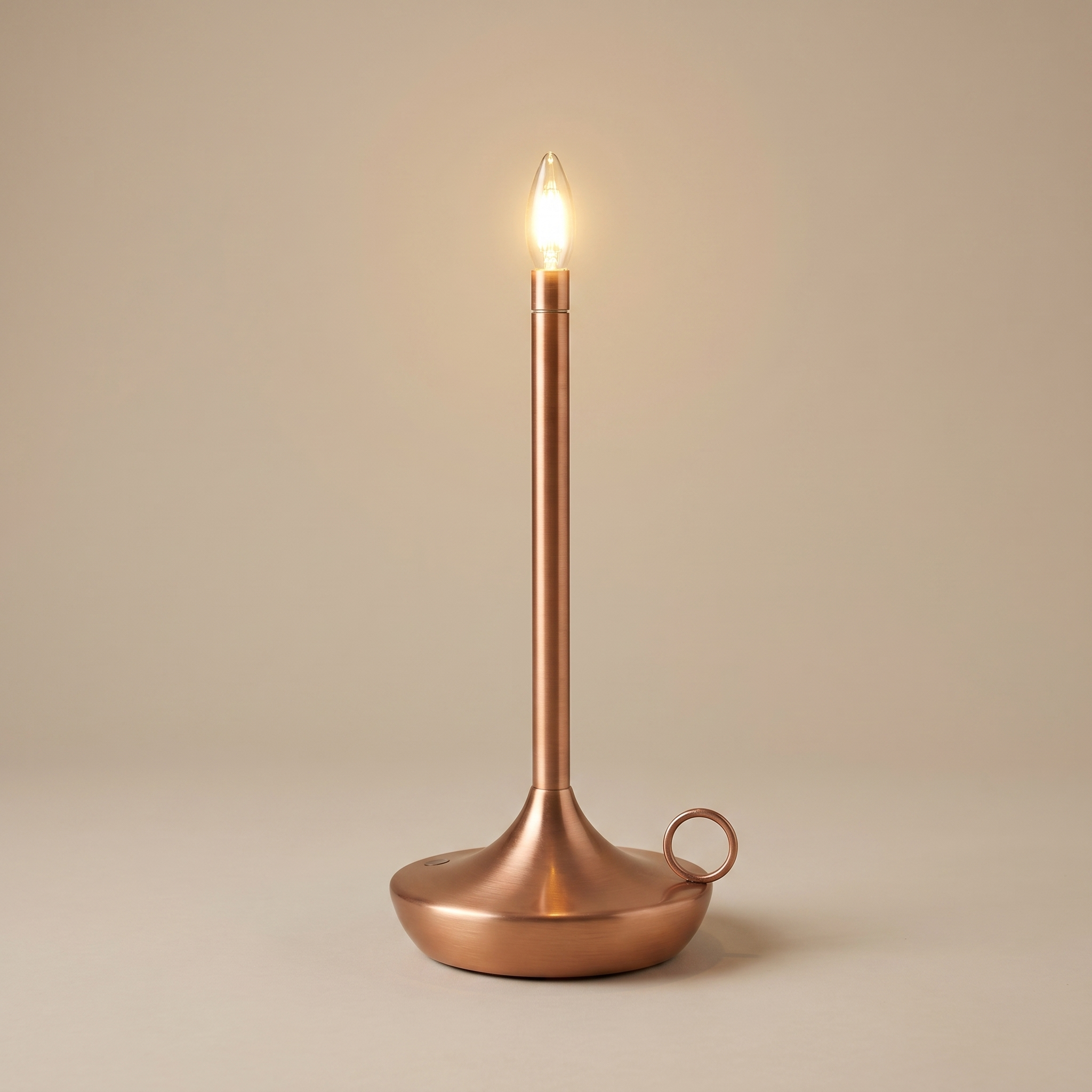 Copper cordless table lamp switched on with a soft warm glow