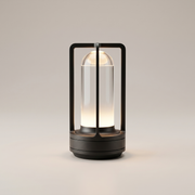 Black metal cordless table lamp on a clean studio background