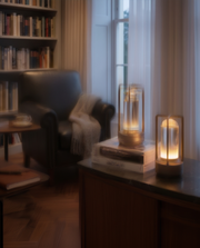 Black cordless table lamp glowing in a reading corner