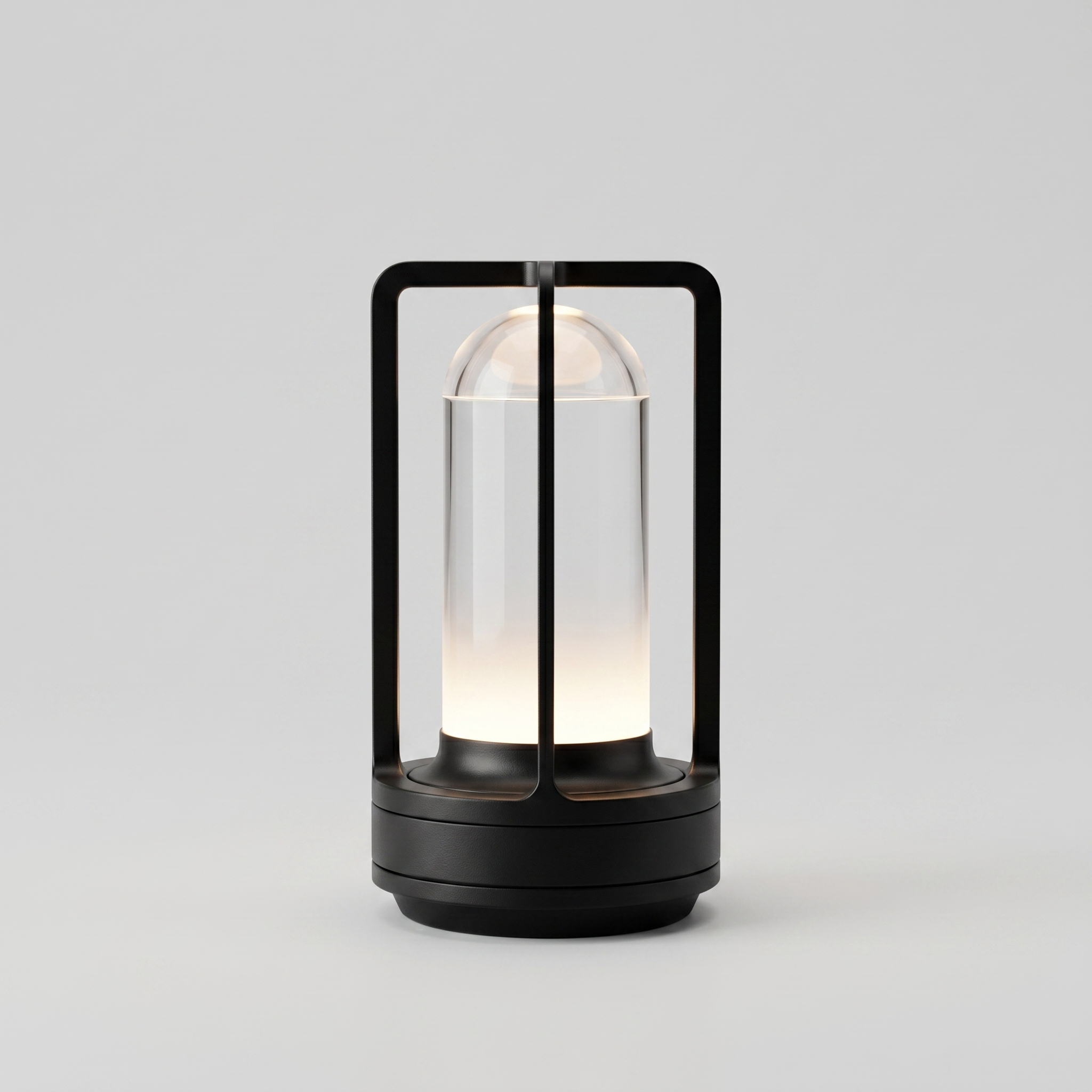 Black cordless table lamp switched on with a soft warm glow