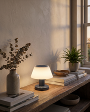 Cordless table lamp glowing on a living room shelf