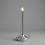 Silver cordless table lamp switched on with a soft warm glow