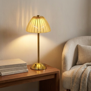 Cordless table lamp adding warm light to a console shelf