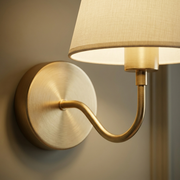 Close-up of brass backplate and fabric shade detail on wall light