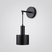 Black wall light with round backplate and cylindrical shade on plain background