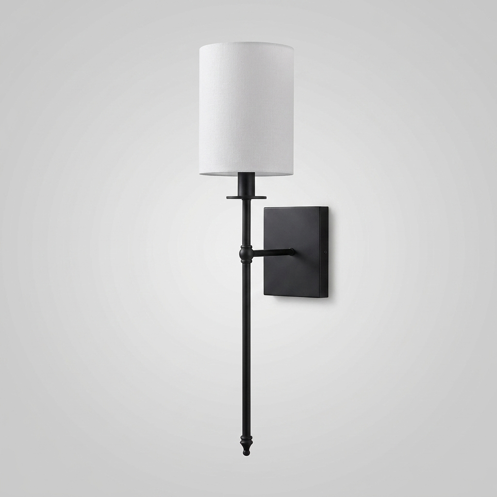 Black candlestick-style wall light with white fabric shade on plain background