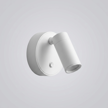 White pivoting wall light with cylindrical head on plain background