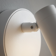 Close-up of backplate and pivot head detail on white wall light
