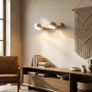 Travertine duo wall light glowing above a living room console table