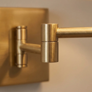 Close-up of gold swing-arm joint and backplate detail