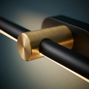 Close-up of brass end mount and black bar finish
