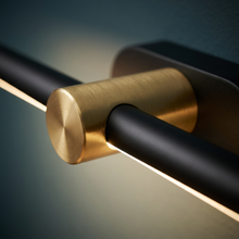 Close-up of brass end mount and black bar finish