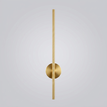 Gold linear wall light on plain background