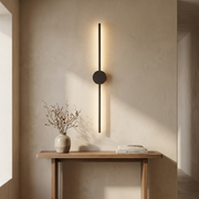 Dark linear wall light above a hallway console table