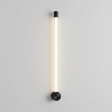 Black vertical linear wall light on plain background