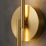 Close-up of gold vertical linear wall light finish and mount