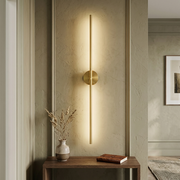 Battery wall light glowing above a hallway console table