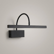 Black rechargeable wall light on a clean studio background
