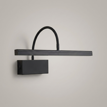 Black rechargeable wall light on a clean studio background