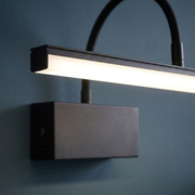 Close-up of the black finish and arm detail of the wall light