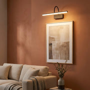 Black linear battery wall light glowing on a living room accent wall